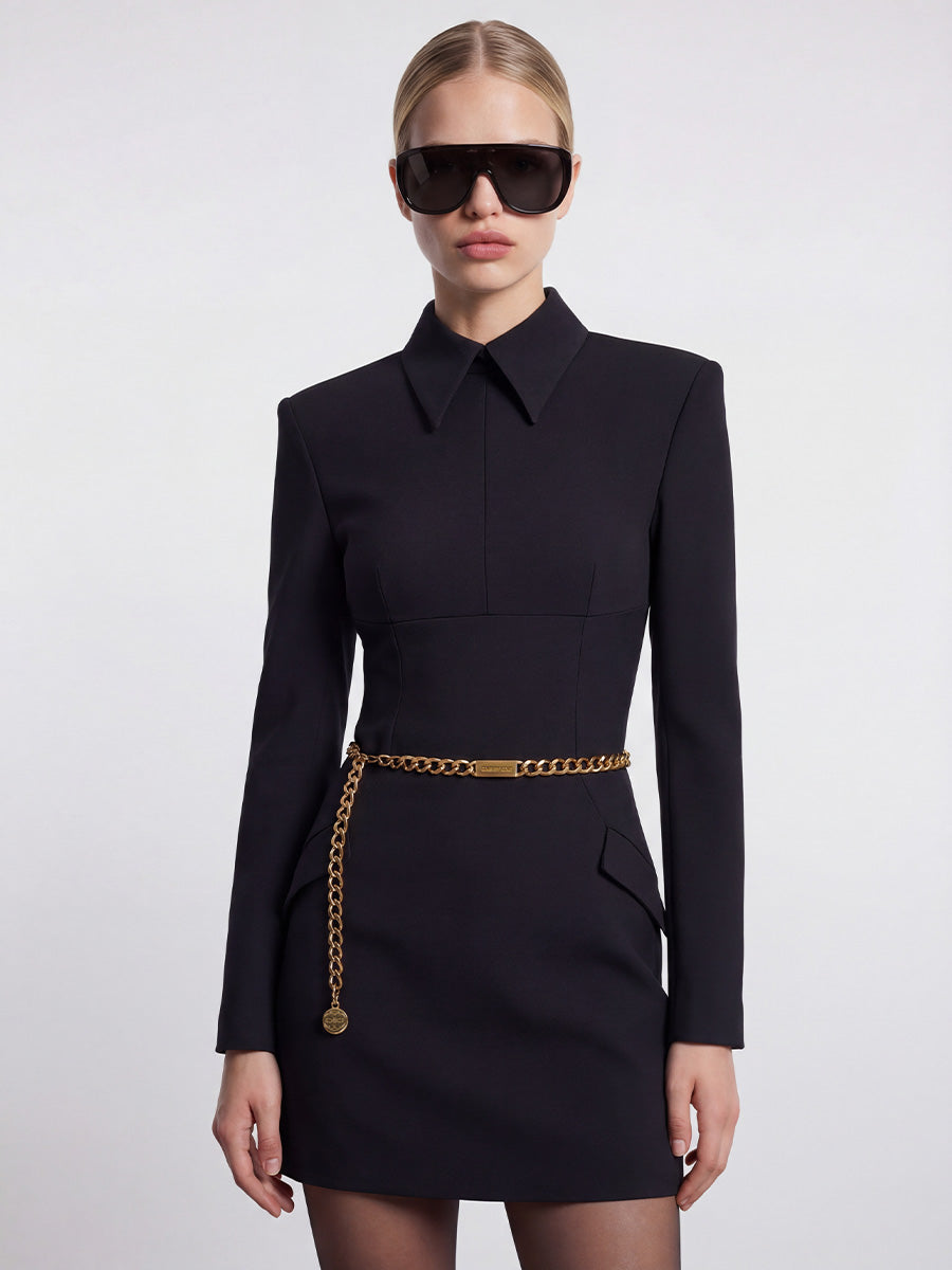 Black dress with a collar and shoulder pads.