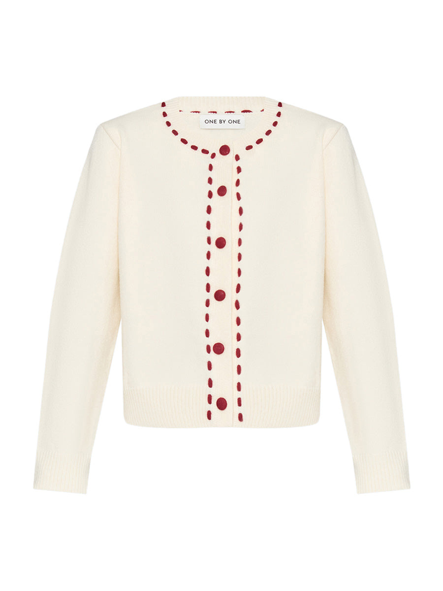 Cream-colored cardigan with red buttons