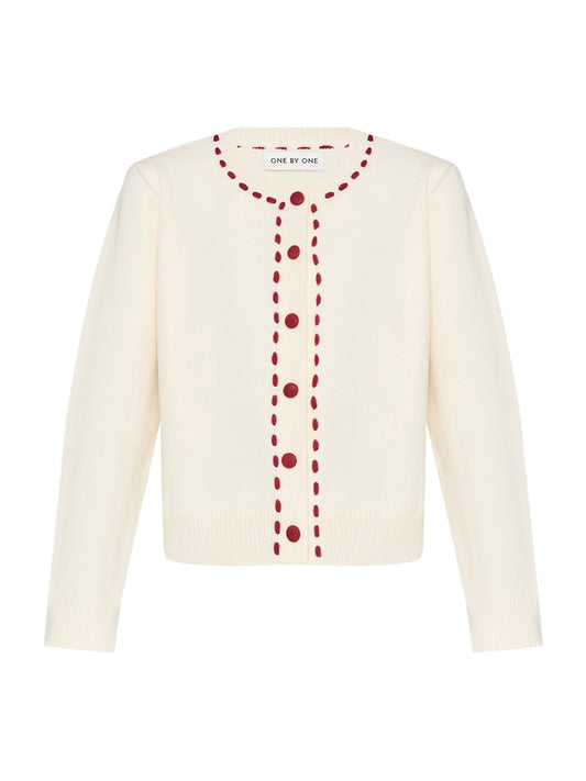 Cream-colored cardigan with red buttons
