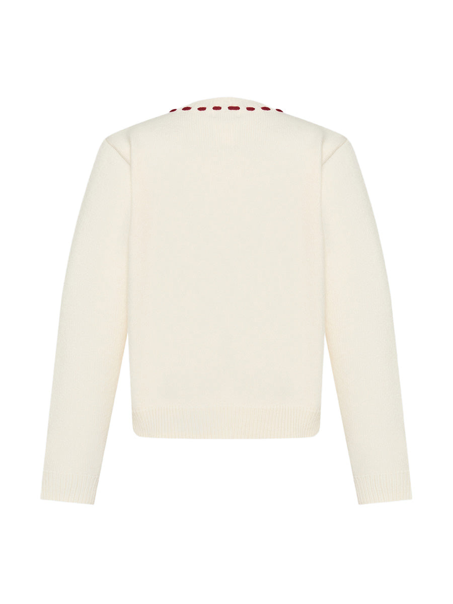 Cream-colored cardigan with red buttons